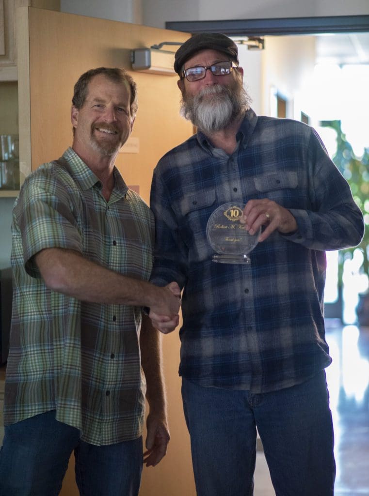 Dan Kline shaking the hand of an person receiving an engineering award