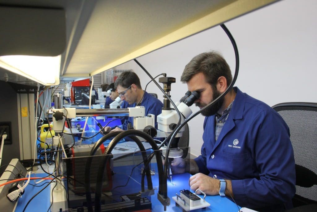 NOVO engineer looking through a microscope
