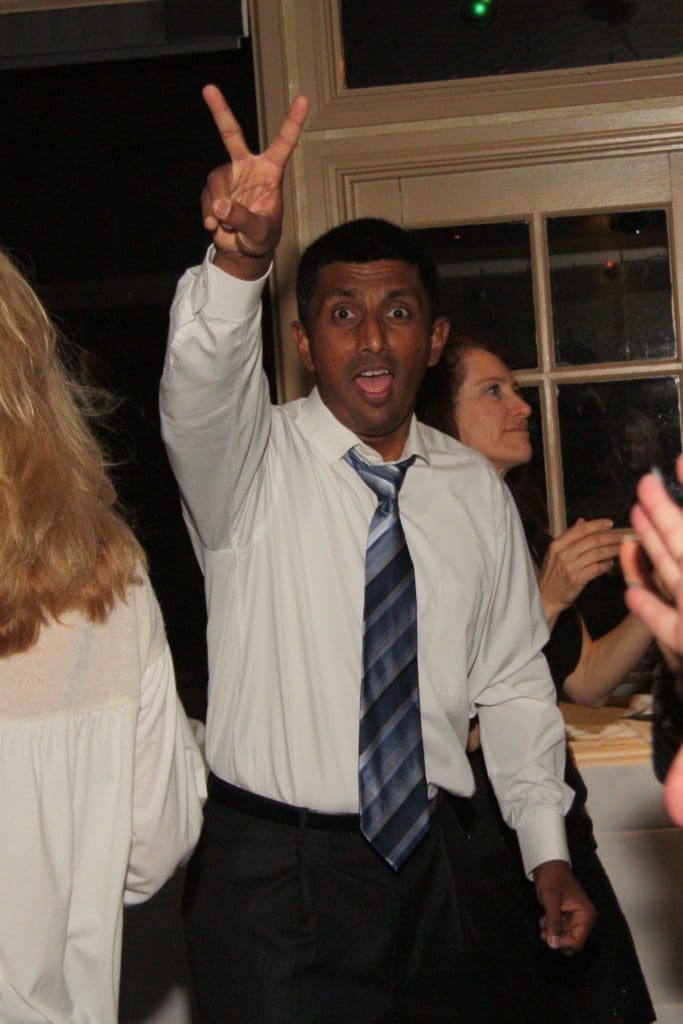Rajan Ramaswamy, president at NOVO engineering making a peace sign with his had at a holiday party