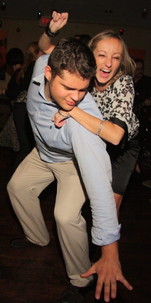 a man and a woman dancing and smiling
