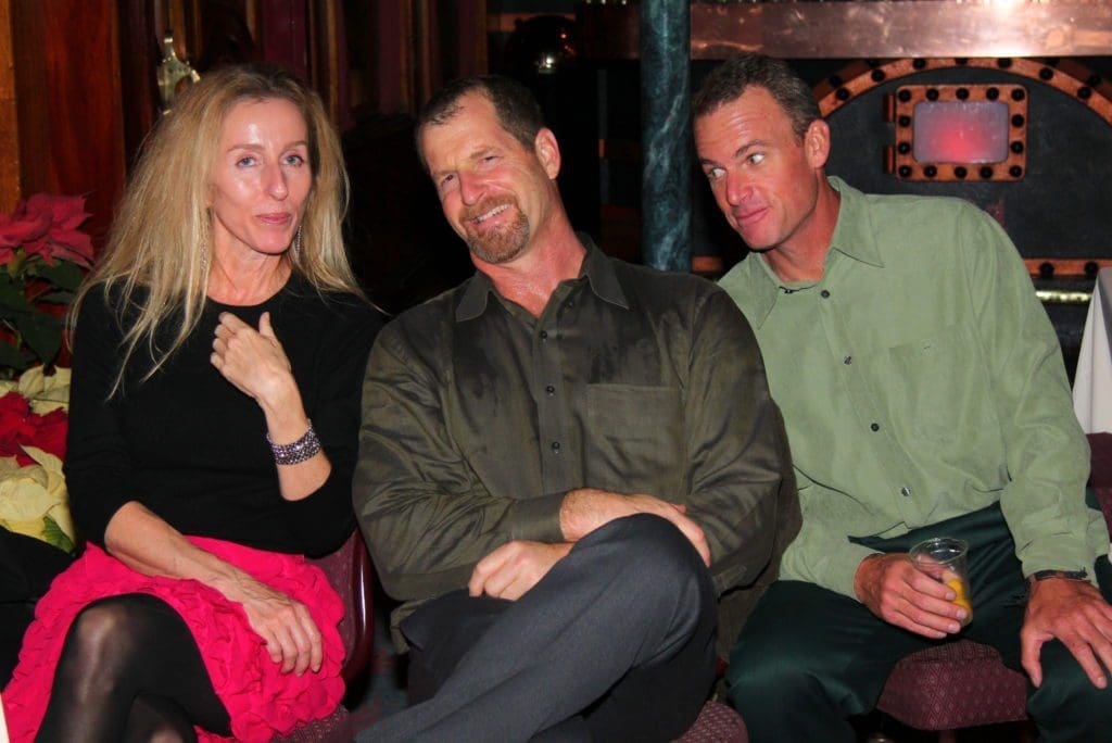 Dan Kline sitting with team members at the NOVO holiday party in San Diego