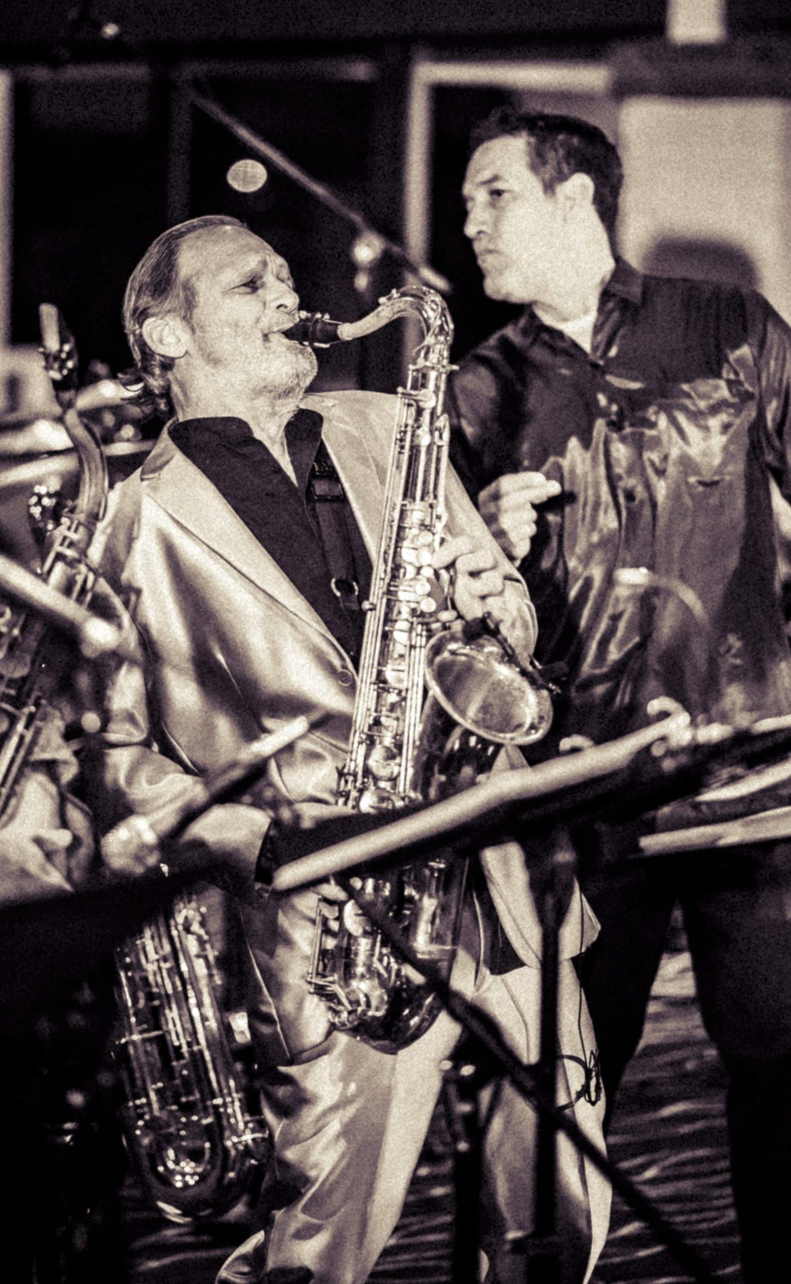 NOVO Engineers having fun playing a saxophone and playing in a rock band on their free time